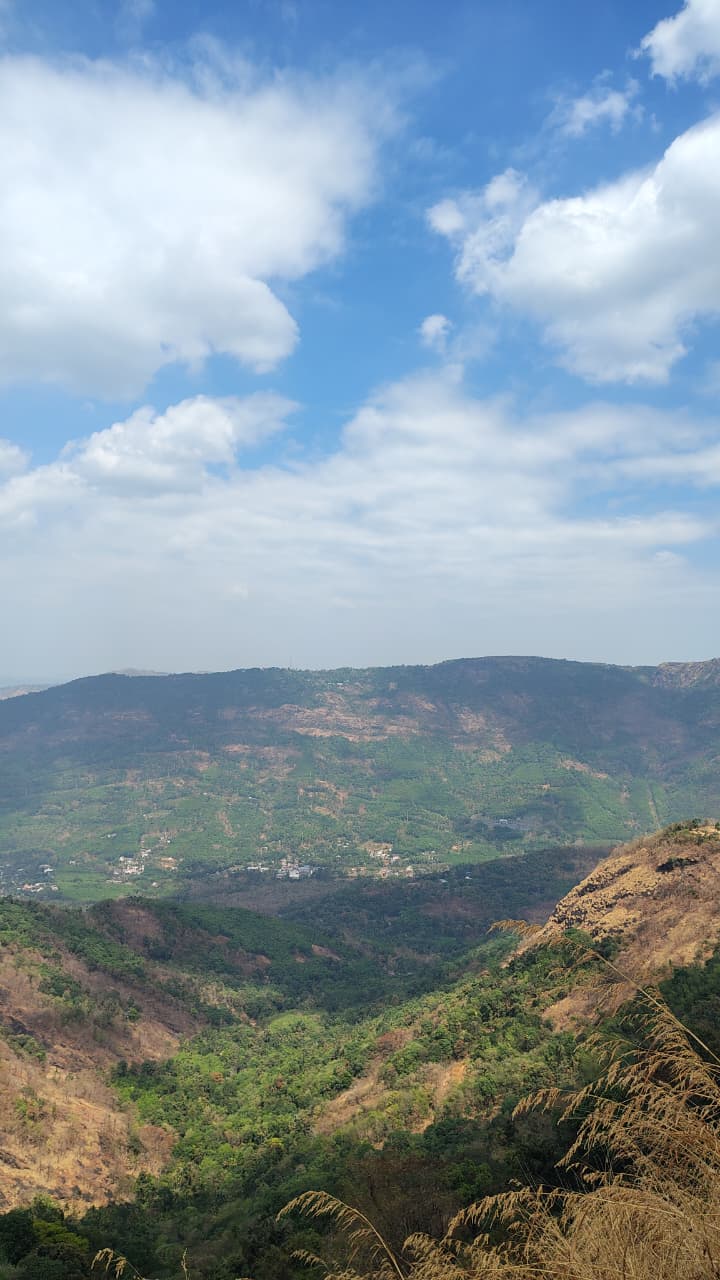 Clouds drifting over the green valleys of Vagamon seen from a hilltop